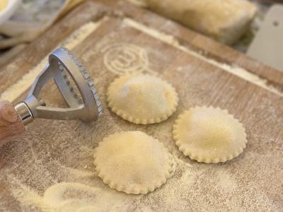 Homemade ravioli preparation on a floured board.