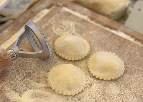 Homemade ravioli preparation on a floured board.